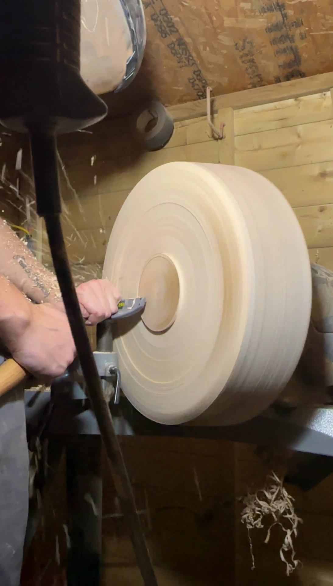 Josh turning a piece of timber on the lathe in the workshop